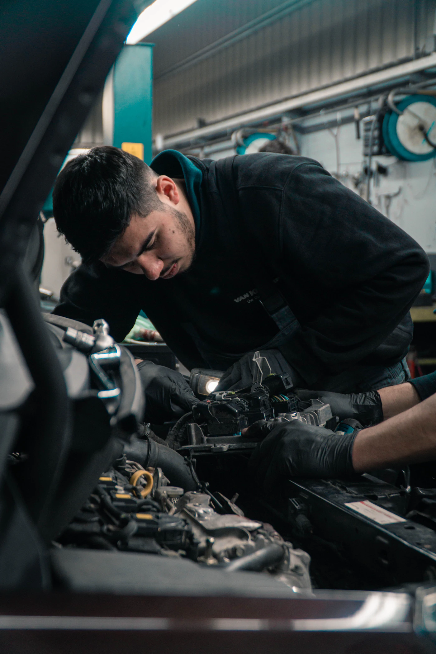 Mechanic working under the hood of a car